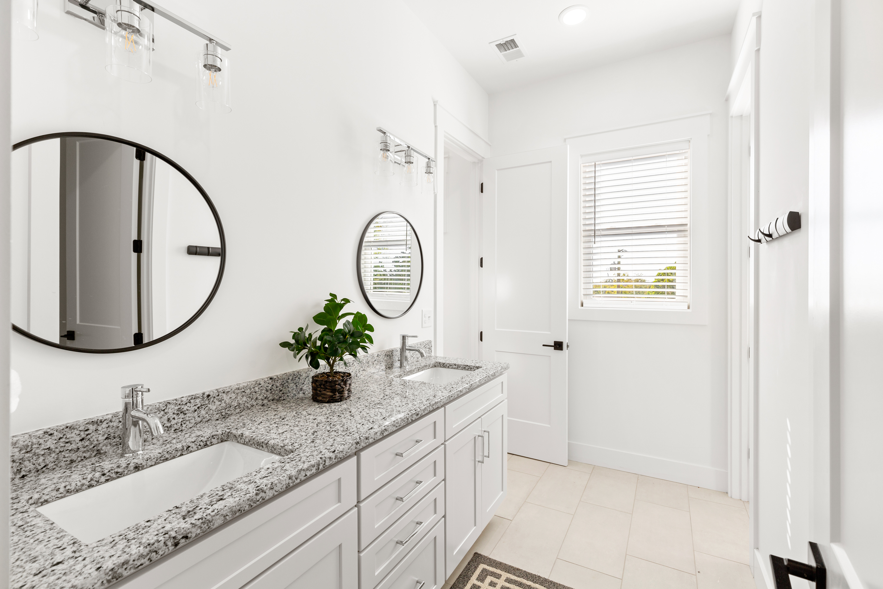 Elegant bathroom with dual sinks and round mirrors